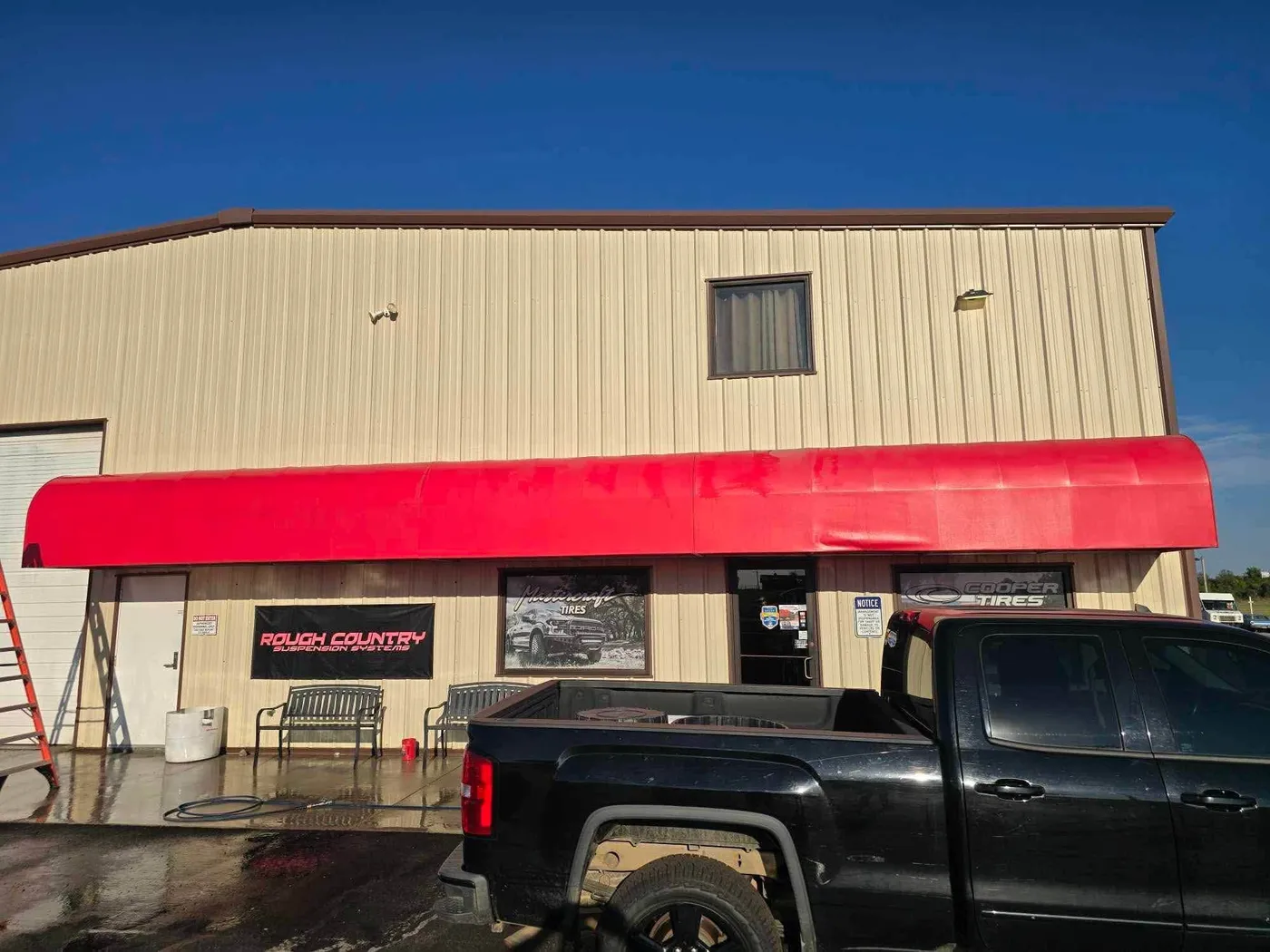 Commercial metal building and red awning after washing