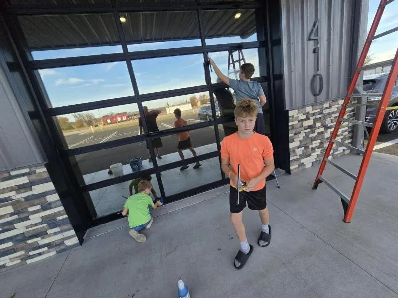 Ryan's crew squeegeeing commercial storefront windows