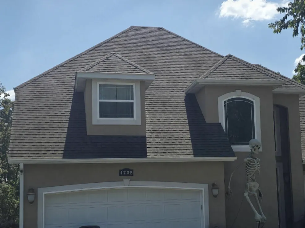 Shingle roof with streaks before washing