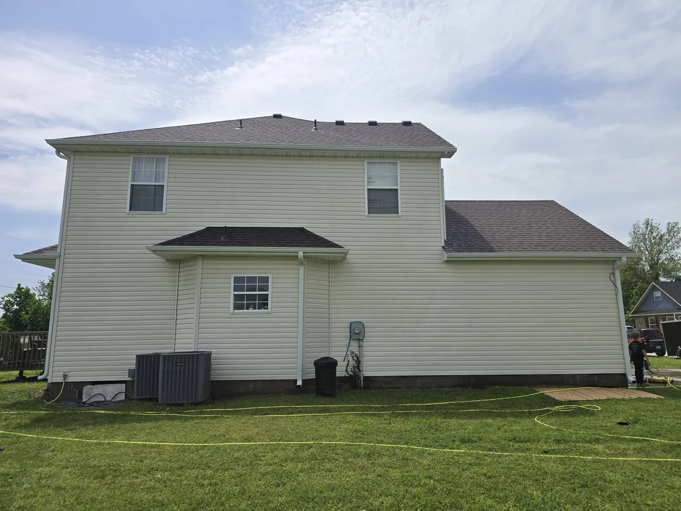 Two-story home with clean siding after a soft wash